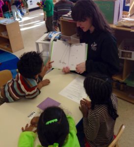 Literacy Lab Pre-K tutor reading a story to students