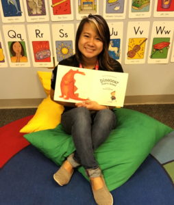 Literacy Lab tutor posing with a story book