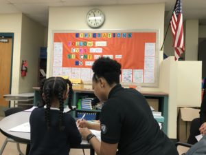K-3 Literacy Lab tutor demonstrating an intervention with a student for supporters