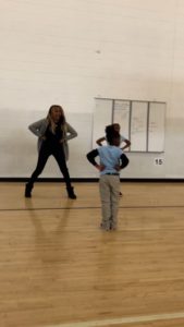 Literacy Lab tutor leading cheerleading practice at school
