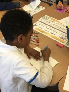 Student writing a birthday card during People Who Are Incarcerated Awareness Day